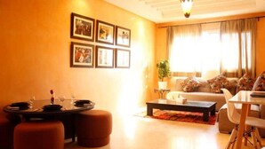 A living room with a dining area, a sofa set, and a coffee table.
