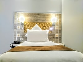 Habitación individual, 1 cama individual grande, baño privado | Ropa de cama de alta calidad y minibar