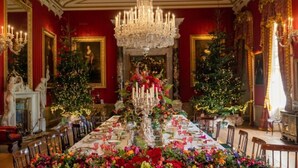A grand dining room with a long table set for a meal, flanked by two Christmas trees and a large chandelier. - Barn-sleeps 4 Alton Towers Scarefest/peak District (Stoke-on-Trent)