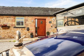 A stone building with a wooden door, a window, and a sign reading 'Cavendish Barn'. - Stylish Cosy Rustic Barn Alton Towers Peaks (Leek)