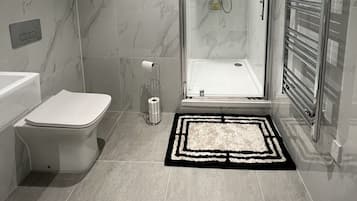 Shower, hair dryer, towels, toilet paper