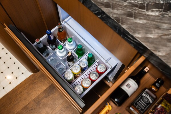 A minibar with various beverages and bottles.