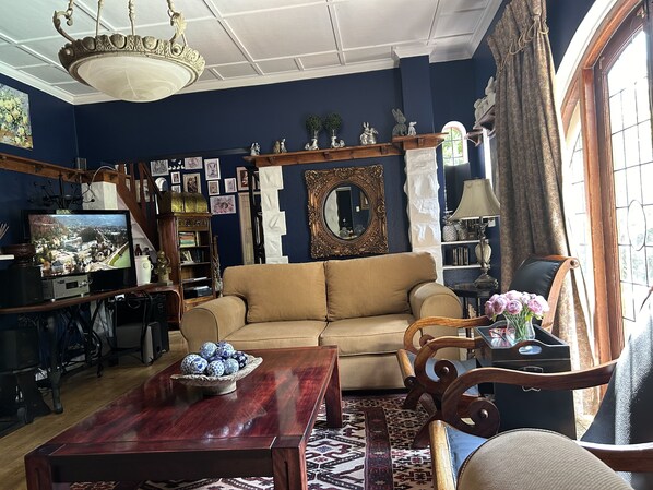 A living room with a sofa, wooden coffee table, and a TV.