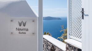 A sign for Nevma Suites with a view of the sea and a white lattice window. - Nevma Suites (Santorini)