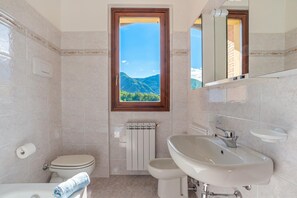 Familie huis, meerdere slaapkamers, 2 badkamers (Lenno Glamour) | Badkamer | Een aparte badkuip en douche, een haardroger, een bidet, handdoeken