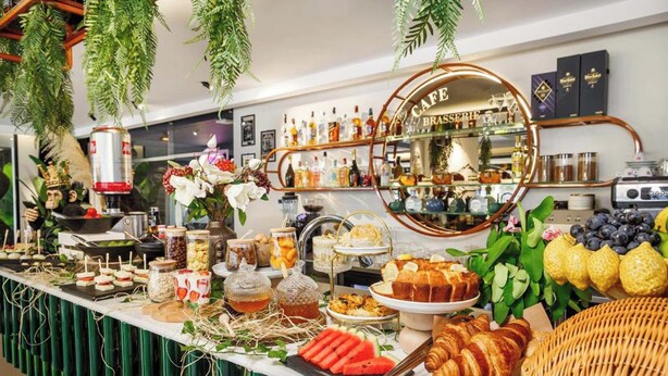 A buffet with various food items, a coffee station, and a bar area with shelves of bottles. - Luff Living Adult Only (+12) (Antalya)