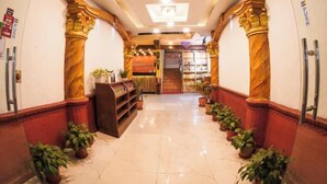 A hotel lobby with marble flooring, wooden columns, and a reception desk. - Hotel Kathmandu Square (Kathmandu)