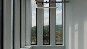 A room with a large window offering a view of a forested area. - ElevenplusOne (Dilijan)