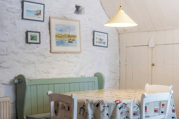 A dining area with a table, chairs, and a bench.
