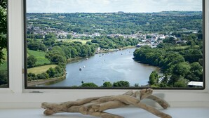 A river view from a window with a rustic branch decoration. - Morawel, St Dogmaels (Saint Dogmaels)