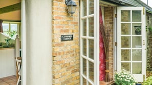A brick exterior wall with a sign reading "CINNAMON COTTAGE". - Cinnamon Cottage, Newcastle Emlyn (Felindre)