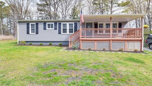 A two-story house with a porch and a small deck. - Toano Home w/ Screened Porch: Steps to Lake! (Toano)