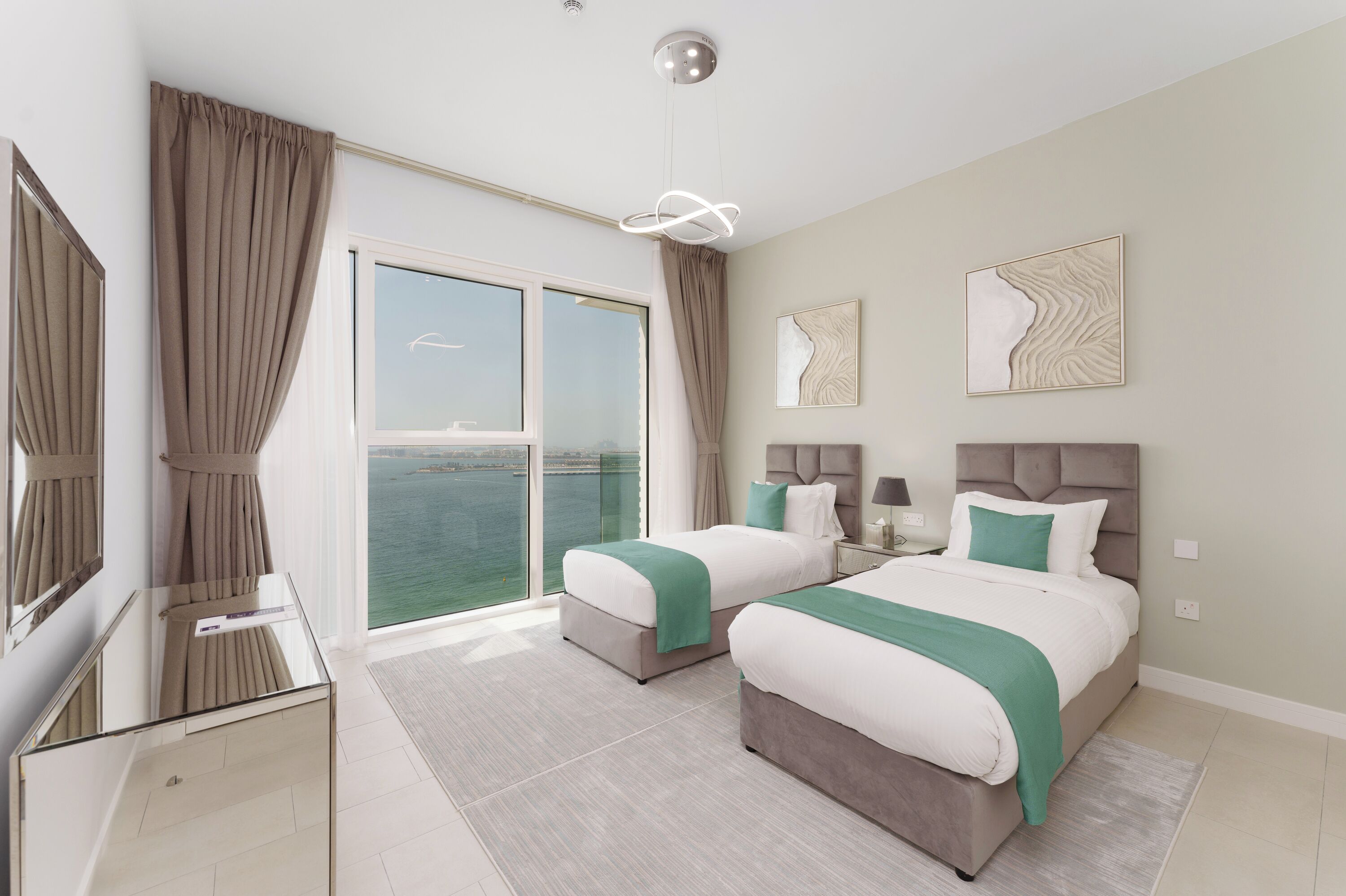 Ein modernes Hotelzimmer mit zwei Betten, einem großen Fenster mit Meerblick, einem Glastisch und moderner Einrichtung.