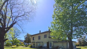 A two-story house with a front porch and a lawn.