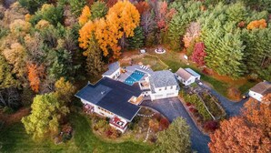 An aerial view of a house surrounded by autumn foliage. - Heated Pool, Hot Tub & Mountain Views on 15 Acres! New Listing Special! (Freehold)
