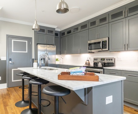 Fridge, microwave, oven, stovetop. Modern East Nashville Home with Elevator & Rooftop Deck