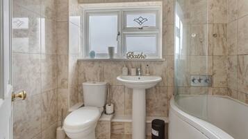 A bathroom with a toilet, sink, and bathtub.
