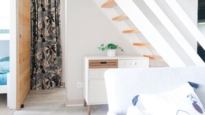 A modern bedroom with a sloped ceiling, a bed, a dresser, and a plant on the dresser. - Pretty flat with ocean and lake views Les Sables - sleeps 4 (Les Sables-d´Olonne)