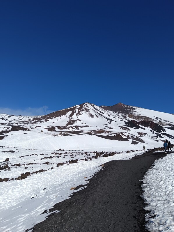 A snow-covered mountain with a clear sky.