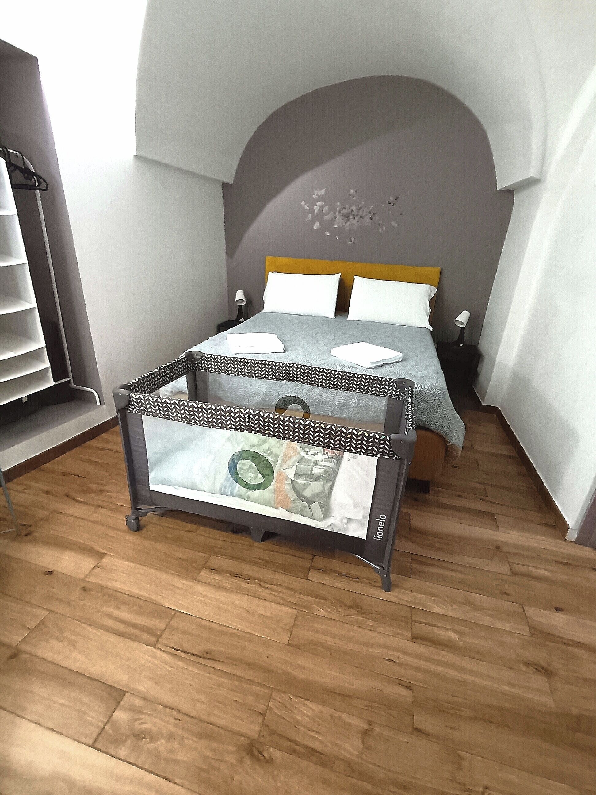 Una camera da letto con un letto, un comodino, una lampada e un tavolino con una rivista.