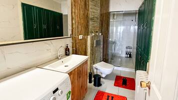 Deluxe Apartment, Sea View | Bathroom | Shower, hair dryer, bathrobes, slippers
