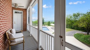 A covered porch with a view of a swimming pool and greenery. - Peony Hill Estate Retreat - The Summer House - Pool & Hot Tub (Lexington)