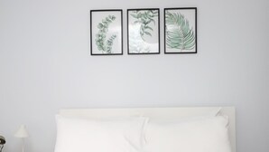 A bedroom with a white bed, white nightstand, and three framed botanical prints on the wall. - ☀ Sunny, Victorian 2BR Townhouse ☀ Oxford - Pass the Keys (Oxford)