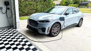 A car charging at a station with a checkered floor pattern. - WELCOME- MARCO ISLAND BEACH LIFEISGOOD STYLISH HOME! FOOD, FUN, SUN & MEMORIES! (Marco Island)