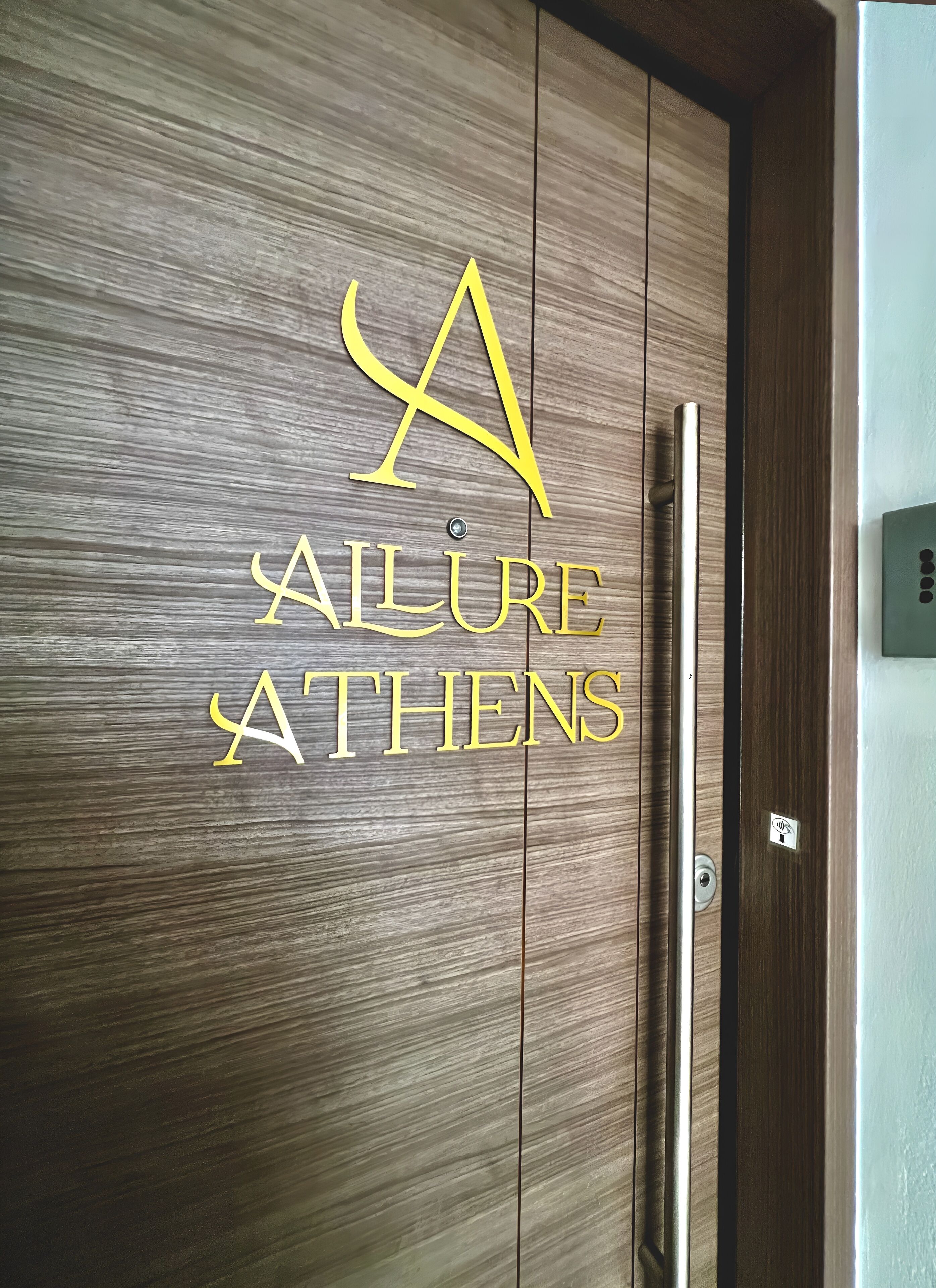 A wooden wall with a logo and the text "A FAILURE ATHENS".