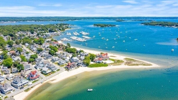 An aerial view of a coastal town with residential areas, a sandy beach, and a marina with boats. - BELLE of the BEACH: 30 ft to gorgeous PRIVATE BEACHFRONT home SLEEPS up to 13 (Wareham)
