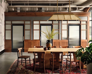 A traditional Japanese-style room with sliding doors, a desk, and a green chair. at Memoir Wedgewood Houston