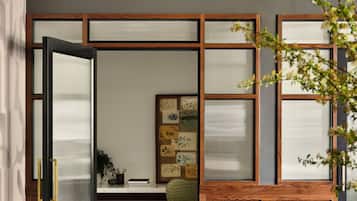 A traditional Japanese-style room with sliding doors, a desk, and a green chair.
