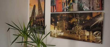 Three paintings of European architecture on a wall.