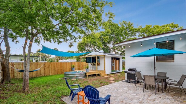 A backyard with a patio, outdoor seating, a barbecue grill, and a small shed. - 1950's Charmer: Bikes/Games/Hot Tub/Fire Pit (Jacksonville Beach)
