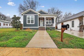 A single-story house with a front porch, a mailbox, and a well-maintained lawn. - Two Homes, One Booking | Sleeps 20 | 6BR/4BA Chattanooga Compound | Hot Tub · Pool Table (Chattanooga)