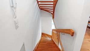 A wooden staircase with a handrail and a phone on the wall. - Gorgeous home in Ueckermünde (Seebad) (Ueckermünde (Seebad))