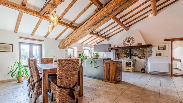 A rustic kitchen with exposed wooden beams, a stone fireplace, and a large clock on the wall. - Il Casale di John - Discover Authentic Italy (Umbertide)