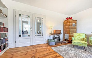 Cozy living room with a bookshelf, door, and cabinet.