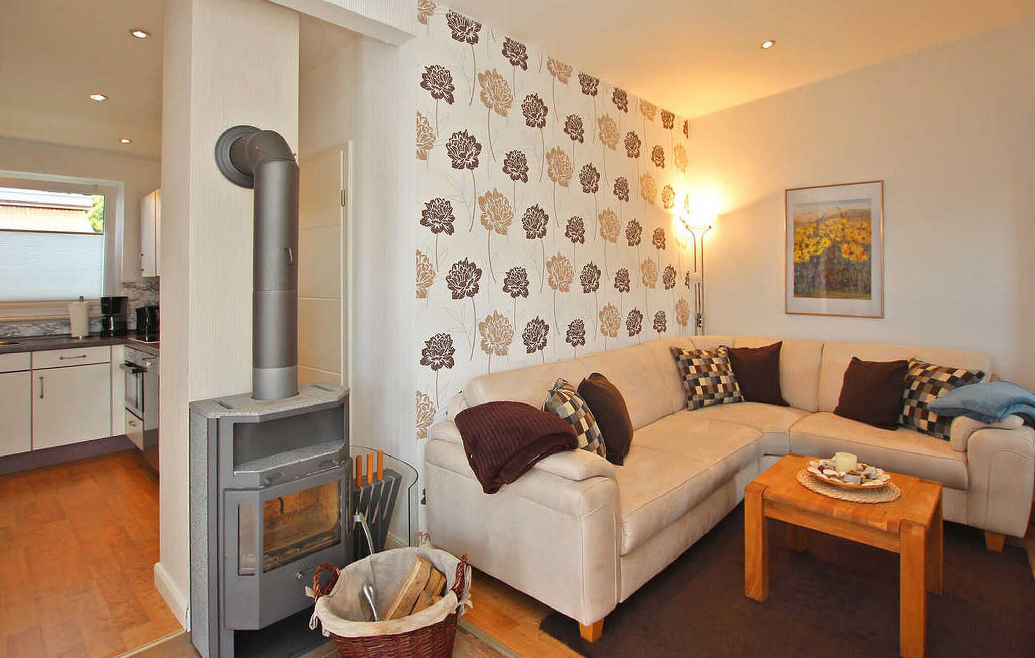 A cozy living room with a sofa, a coffee table, and a fireplace.