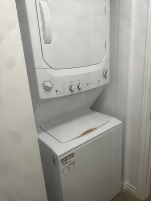A front-loading washer and dryer unit with control knobs and a label indicating it is ENERGY GUIDE rated 810. - 2 Bedroom Centrally Located, Stephenville, NL (Stephenville)
