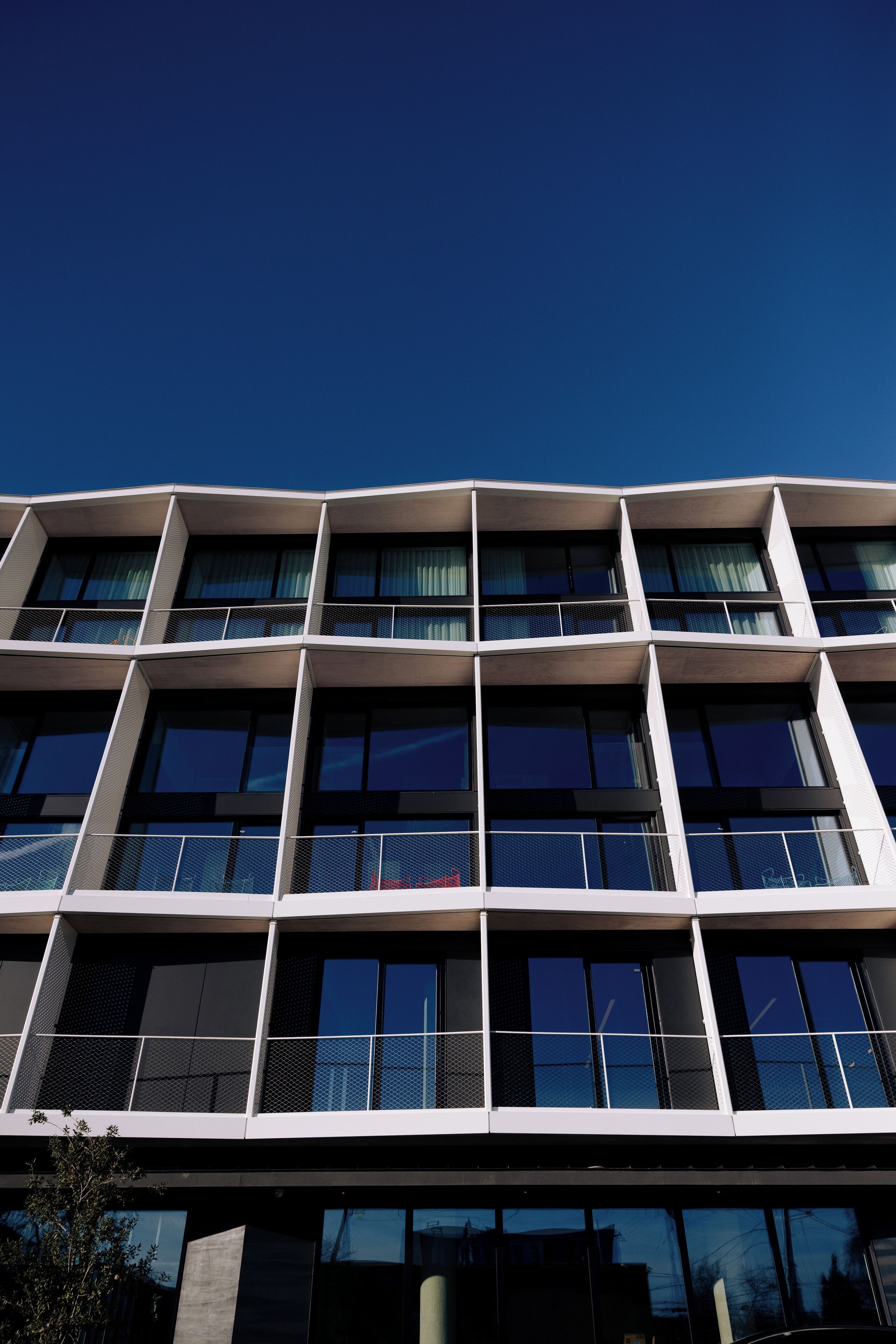 A modern building with multiple floors and large windows.