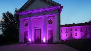 A building with a classical architectural style, featuring a central entrance with columns and a pediment. - Ferienwohnung Rheinsberg (Rheinsberg)