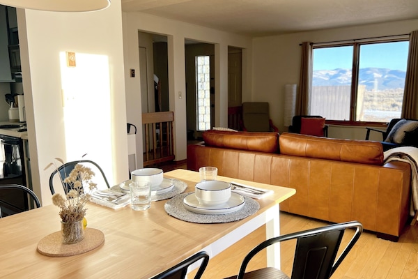 Open-concept living and dining space with mountain views