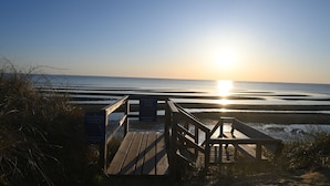 A wooden boardwalk leading to a beach with a sign indicating it is part of the Rye Beach Association. - Cape Cottage with 5 beds, large deck, and less than 10 minute walk to the beach! (Eastham)