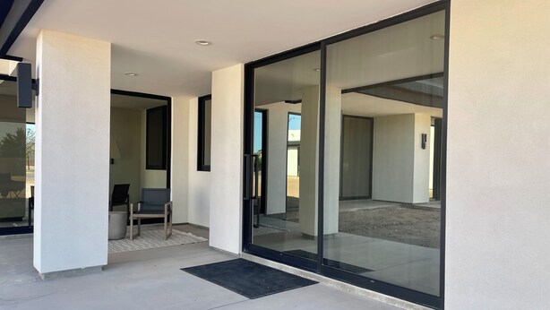 A modern building with large glass doors and a concrete floor. - Luxurious King Suite in Gilbert. Kids are Welcome! (Gilbet)