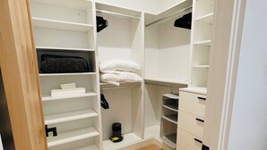 A walk-in closet with open shelves, a hanging rod, and a shoe rack. - Luxurious King Suite in Gilbert. Kids are Welcome! (Gilbet)