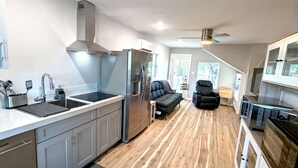 A modern kitchen with stainless steel appliances, a built-in oven, and a large window. - Lake Fork Luxury and Leisure. 2 story cabin in gated resort. Many amenities! (Quitman)