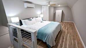 A bedroom with a bed, white walls, a ceiling fan, an air conditioning unit, and a wardrobe. - Lake Fork Luxury and Leisure. 2 story cabin in gated resort. Many amenities! (Quitman)
