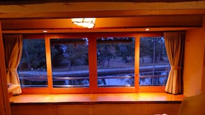 A room with a wooden floor, a window with curtains, and a chair. - WAIN TO OYADO CHITOSE (Miyazu)