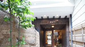 A narrow entrance with a wooden archway leading to a building. - WAIN TO OYADO CHITOSE (Miyazu)